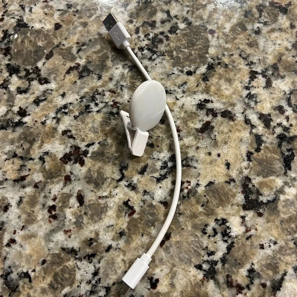 White Mini phone light with clip and  Charging Cable